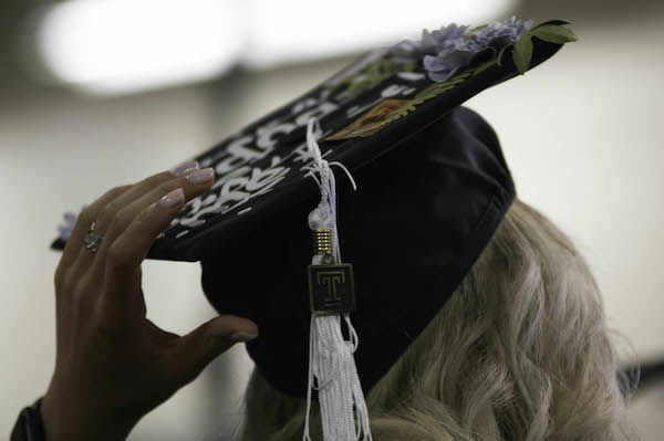 image of graduate holding her cap