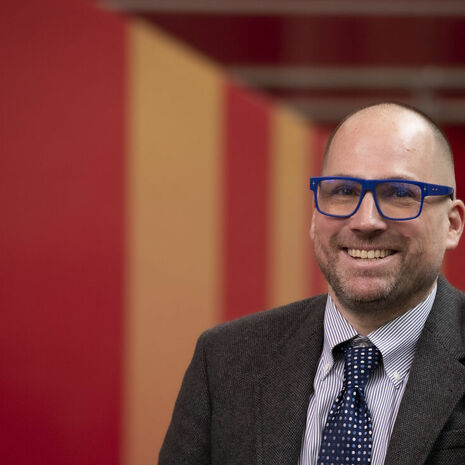Dustin Kidd wearing blue glasses 