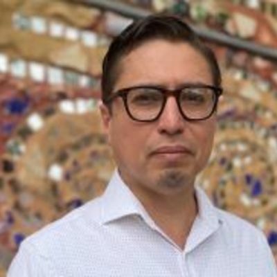 image of Franklin wearing glasses and looking at the camera