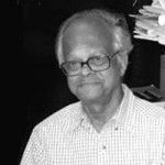 black and white image of Jitendra Nath Mohanty wearing glasses and a white button down shirt