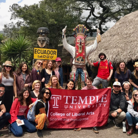 Latin American Studies Students hold College of Liberal Arts banner while abroad in Ecuador