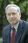 image of Joe McLaughlin in a red tie and dark grey suit