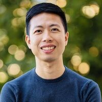 image of Steven standing outside wearing a blue shirt and smiling at the camera
