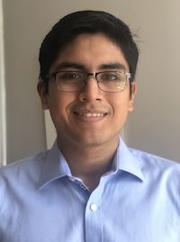 image of César Cabezas wearing glasses in a blue button down shirt