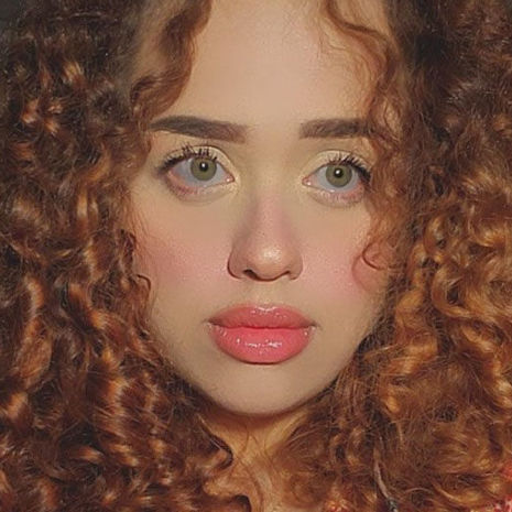 selfie image of Yomarilis Gueits Rodriguez in a orange dress