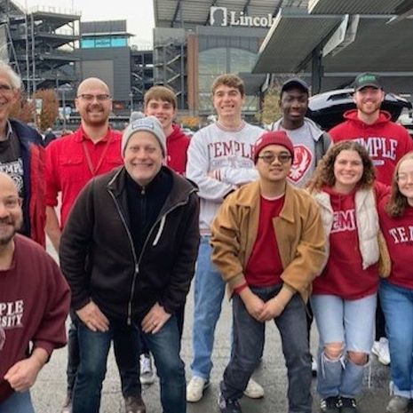 group photo of faculty, satff and students at Lincoln Financial Field parking lot