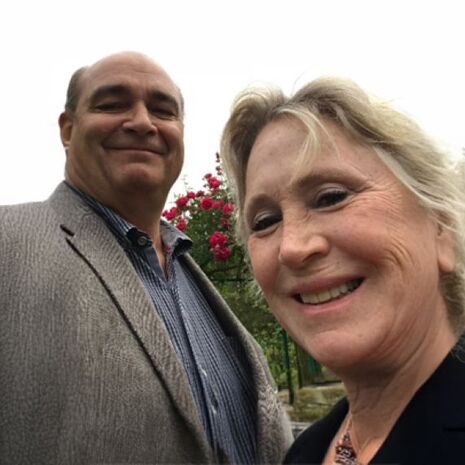 image of Patrick H. Tolan and his wife Virginia Evans standing in a garden smiling at the camera