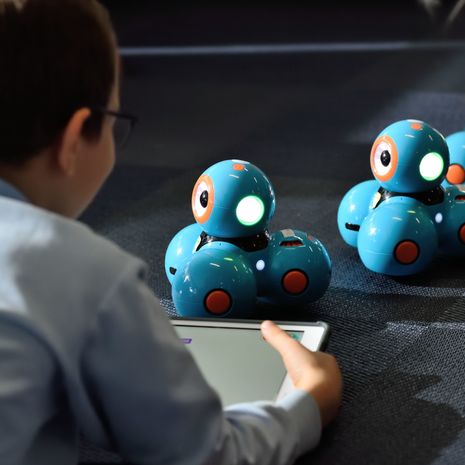 Image of a child playing with robot toys.