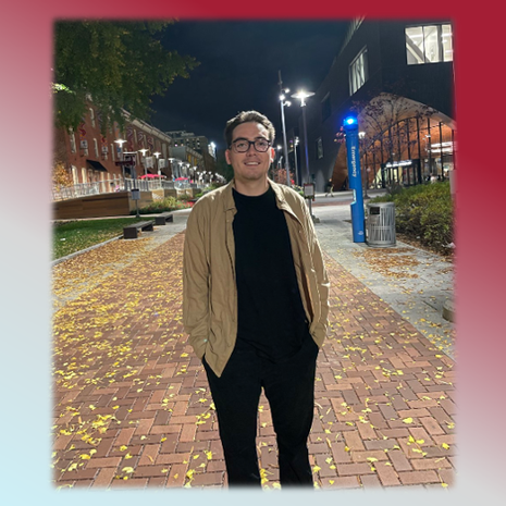 image of Ryan Jennings standing in Polett Walk, in black pants and a tan jacket