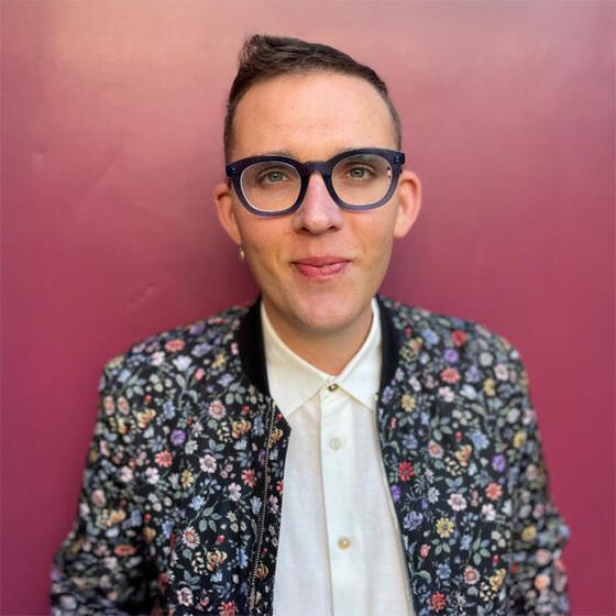Bench Ansfield in a floral jacket and white shirt staring into the camera