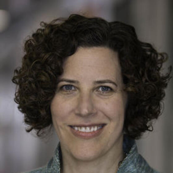 Judith Levine smiling and staring into the camera
