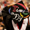 image of student holding her graduation cap