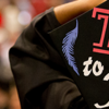 image of student holding her graduation cap with the words time to fly