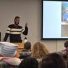 image of Jared standing in front of a room giving a presentation