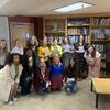 image of Liz Moore a poet and students after a poetry reading in a lounge at Temple