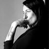 black and white image of Amanda standing with her hand on her chin