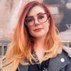 Isobel Connors standing outside in a black jacket looking into the camera