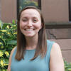 image of Kacie wearing a teal dress smiling at the camera