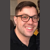 image of Paul wearing glasses and smiling at the camera