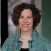Judith Levine smiling and staring into the camera