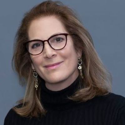 image of Natasha Rogoff, wearing glasses, wearing a black turtleneck 