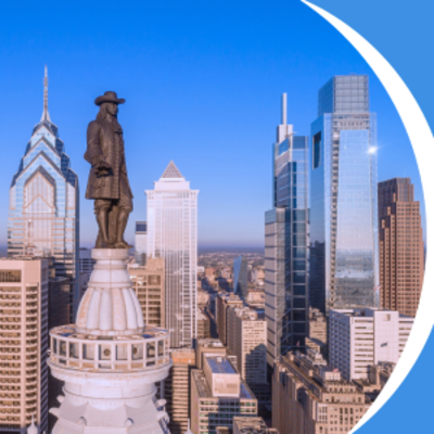image of Ben Franklin statue in center city Philadelphia with the skyline of the city behind