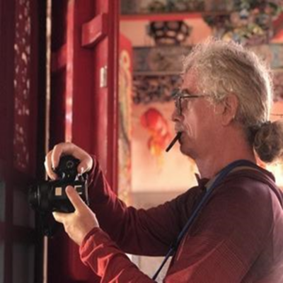 image of Oliver taking a photo in a Temple in China
