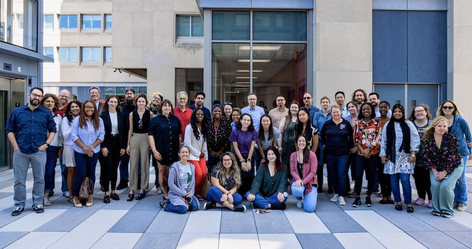 image of CJ students and faculty standing and sitting outside in a group photo
