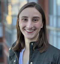 headshot of Gretchen standing in a green jacket and blue shirt