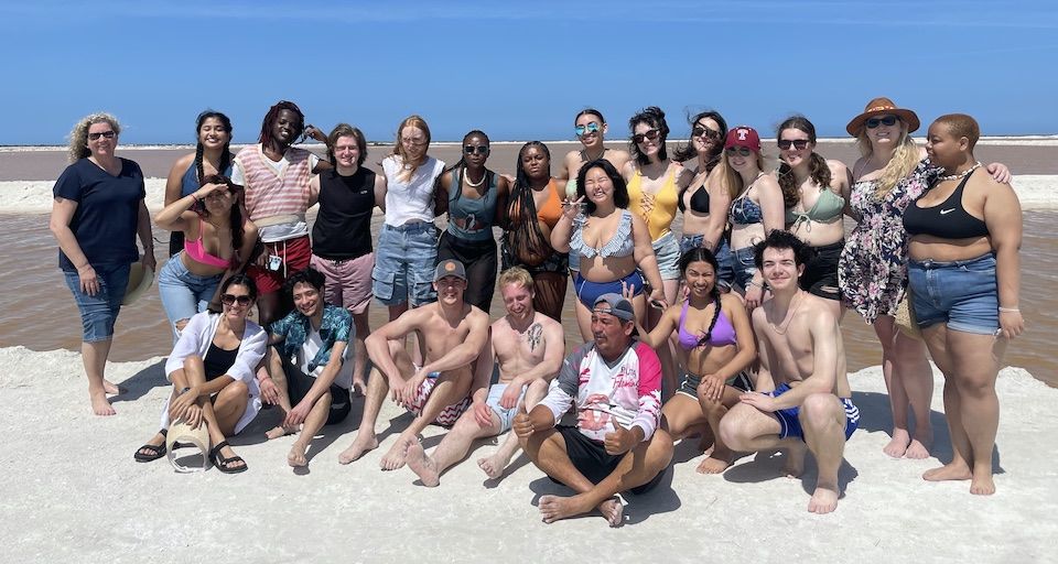 group image of Monserrat and students on the beach 