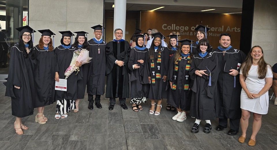 image of the class of '24 MPP Graduates in a group in their caps and gowns