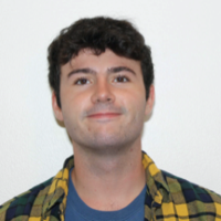 image of VIncent Tumolo in a yellow flannel and blue tee shirt