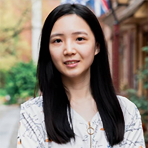 image of Ching-hsuan wearing a floral blouse smiling at the camera with the city behind her