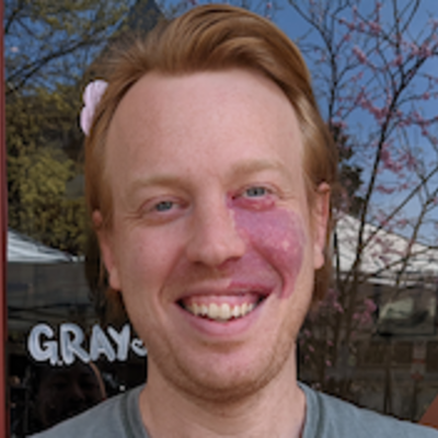 headshot of Matt Graham standing in front of the Student Center at Temple University