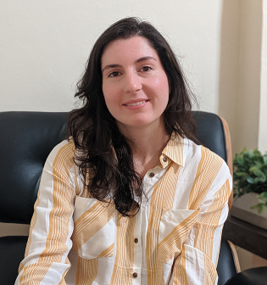 image of Viviane sitting in a yellow and white striped blouse