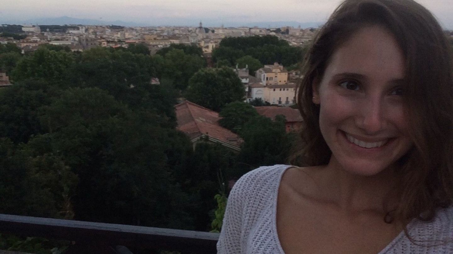 College of Liberal Arts Italian Major Alexa Gingerich poses on a balcony overlooking a town