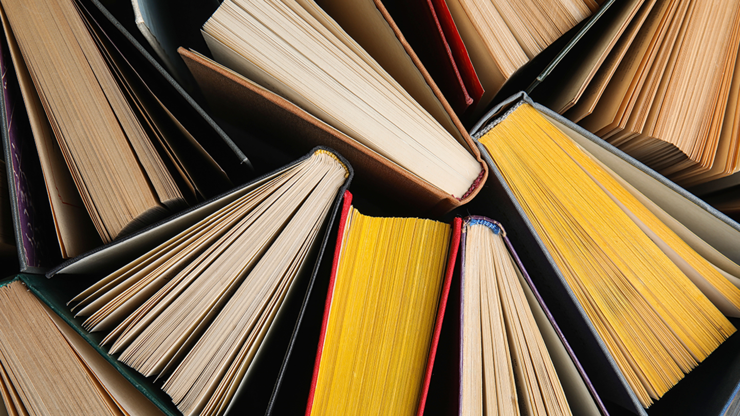 Pages and spines of books clustered together from a bird's-eye view