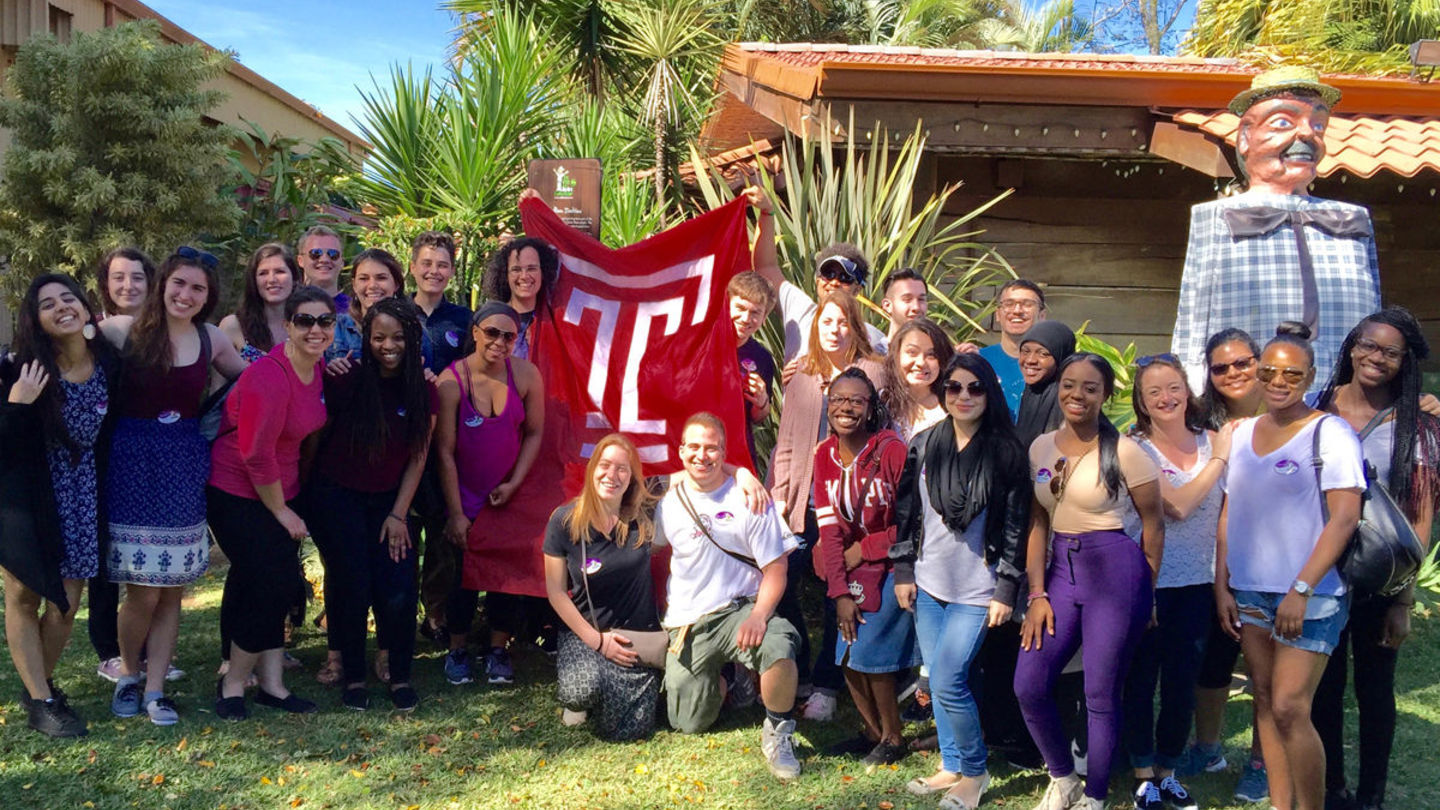 Latin American Studies Students stand with the Temple University flag in Costa Rica