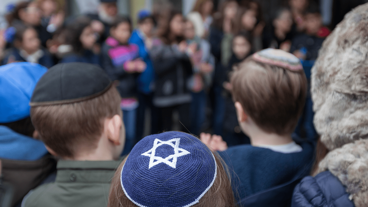 A crowd of Jewish people stands together