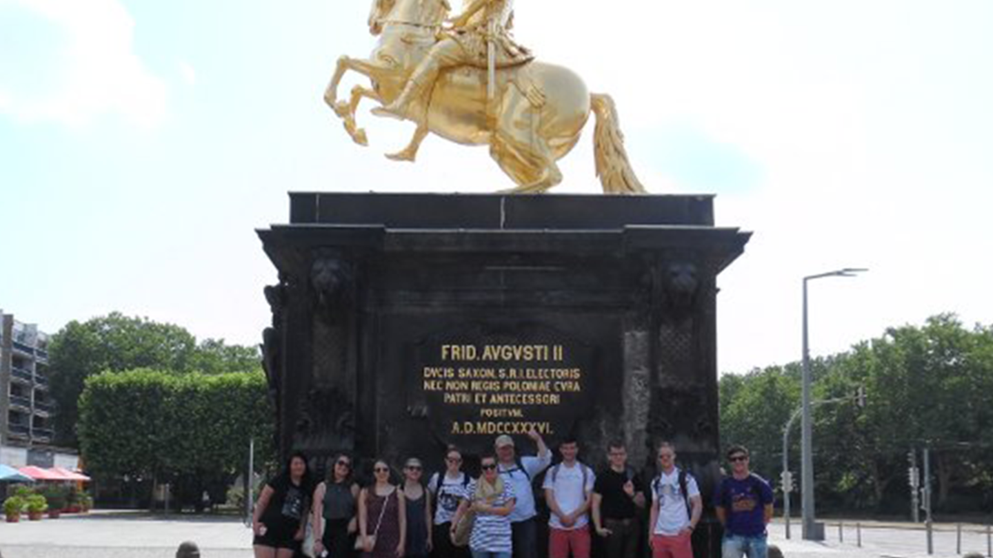 College of Liberal Arts students pose together in front of a statue in Leipzig, Germany.