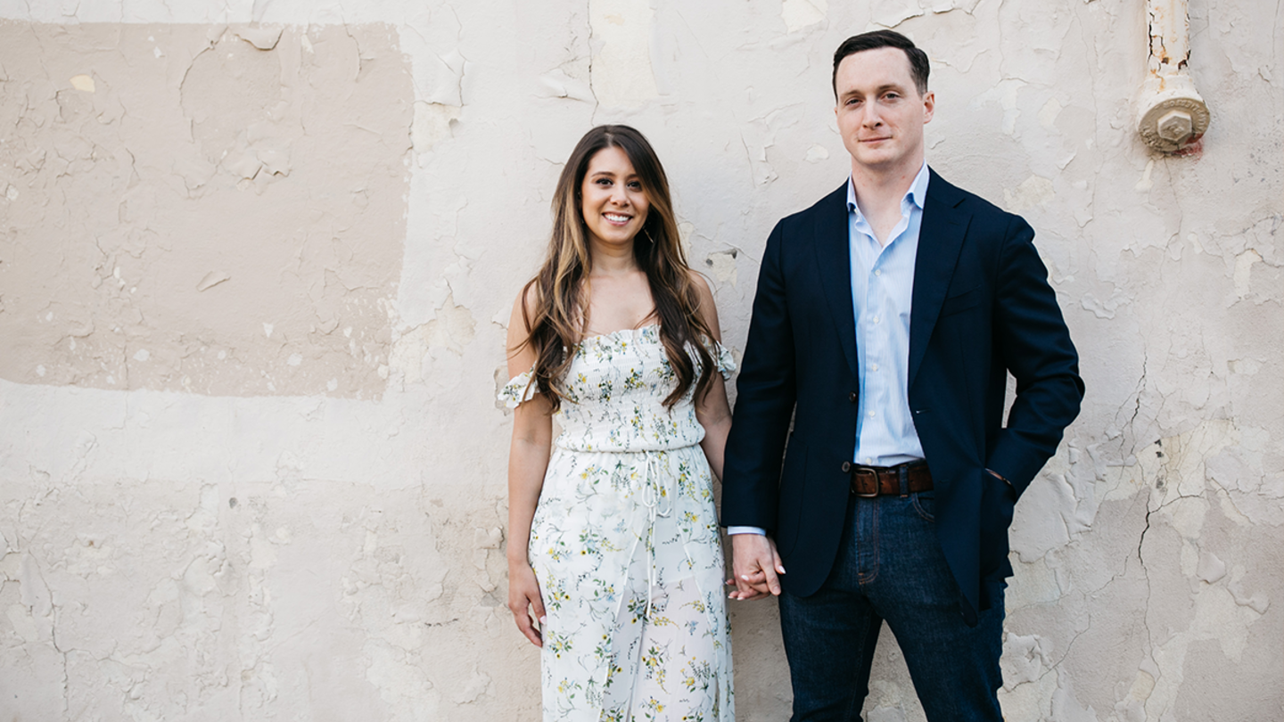 Married College of Liberal Arts alumni Vicki Cram Jon Hood stand hand-in-hand