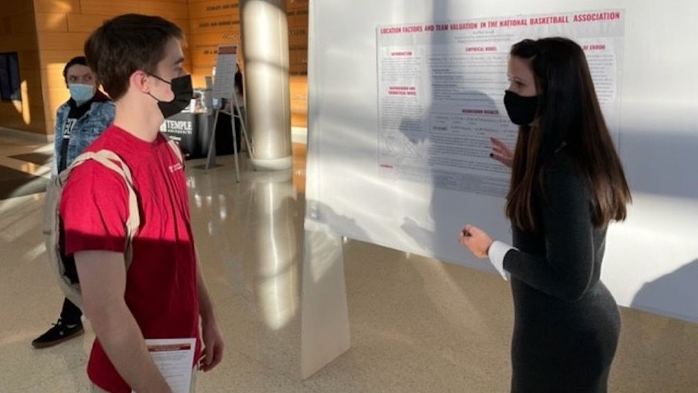 image of Rachel Small presenting her research poster