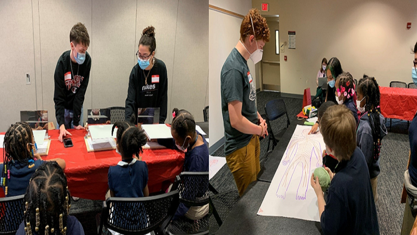 image of students with elementary school kids at Brain Awareness week