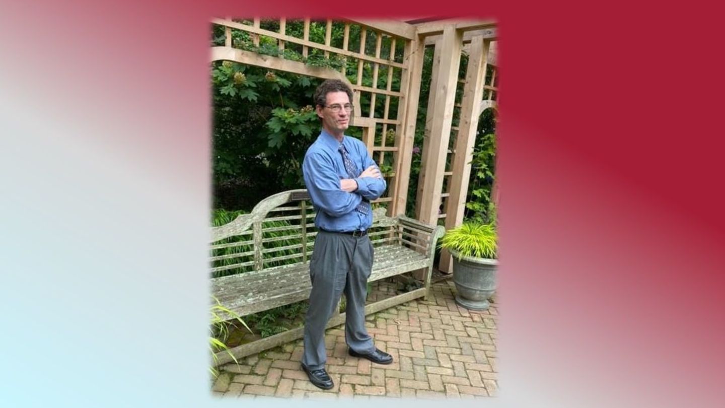 image of student Rhymes Humphreys standing in a garden with his arms crossed