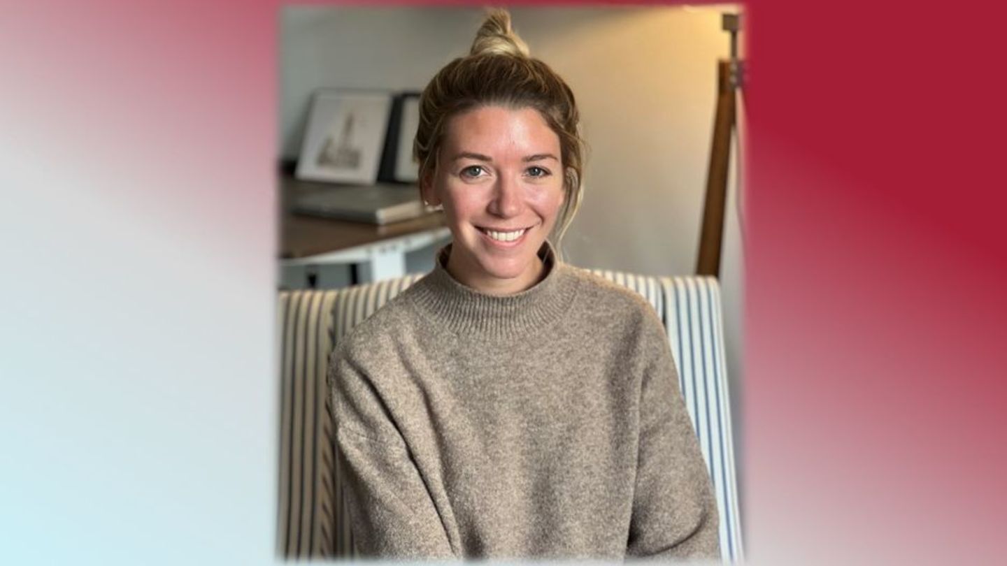 image of alumni sara denault sitting on couch with tan sweater