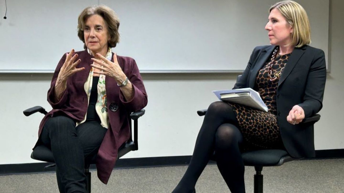 image of Marjorie Margolies sitting having a conversation with a member of the womens justice league 