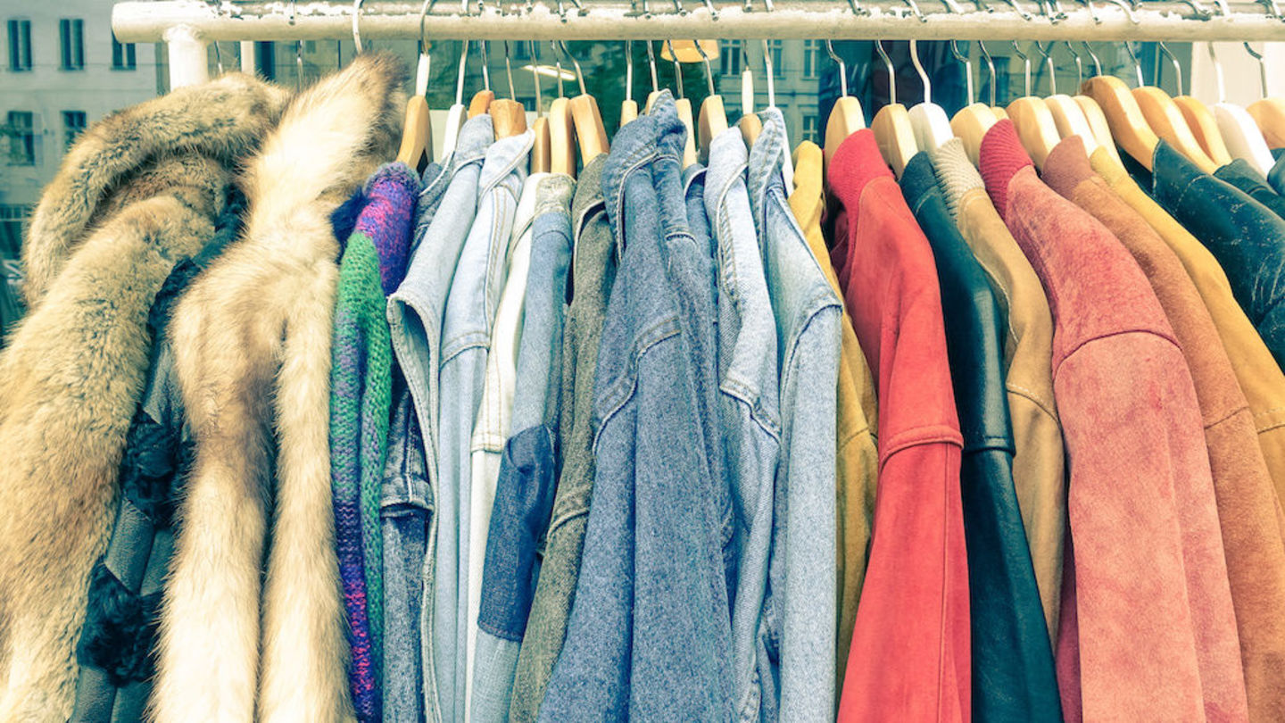 image of various clothing garments in various colors having on a rolling clothes rack