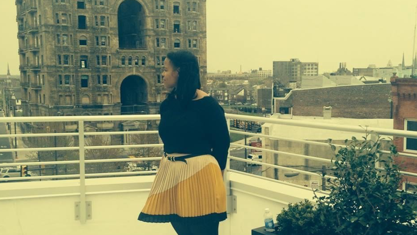 image of Cheryl standing on the rooftop of a building on Broad St in Philadelphia 