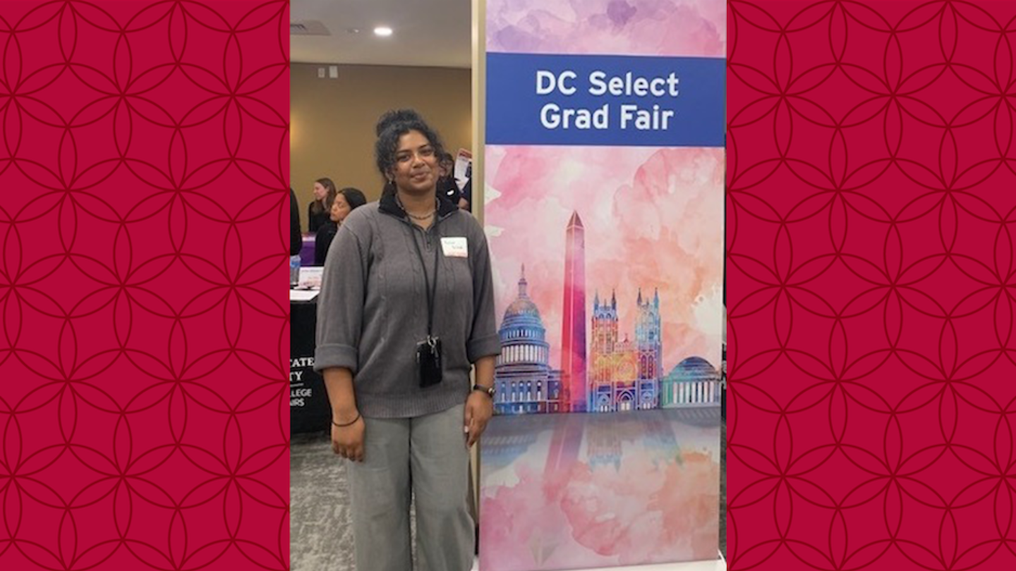 image of Reema standing next to a DC Select Grad Fair sign