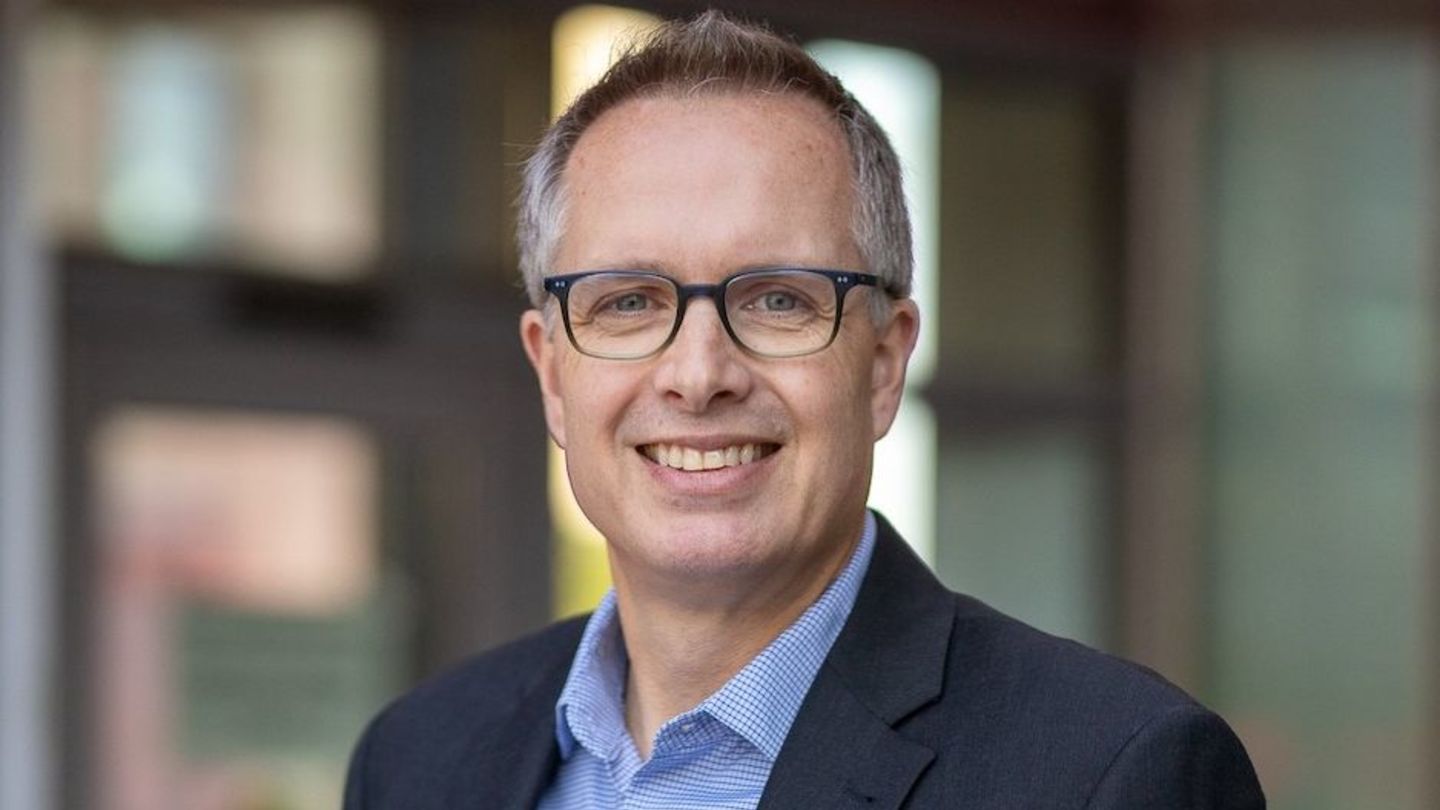 Professor Jerry Ratcliffe image of Jerry wwearing glasses a grey suit jacket and blue dress shirt smiling at the camera